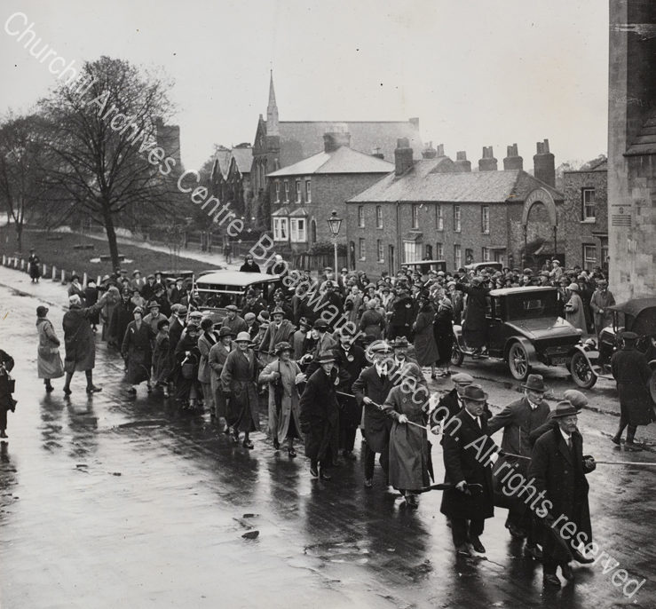 Photo of a busy street scene [in Essex]. WSC and CSC are standing in the back of an open topped car