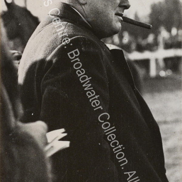 Photo shows WSC in profile with a hat pulled down over his eyes and a cigar in his mouth.