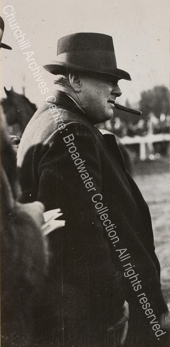 Photo shows WSC in profile with a hat pulled down over his eyes and a cigar in his mouth.