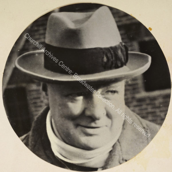 Photo of WSC smiling and wearing a hat and scarf.