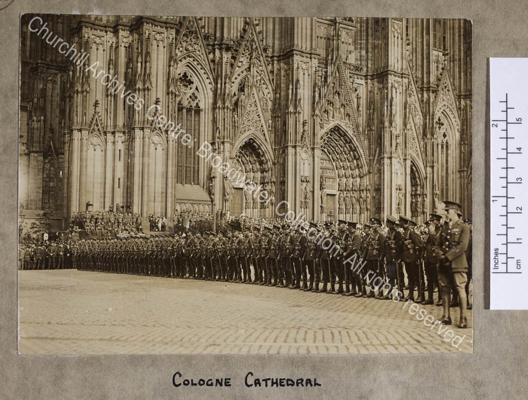 Photograph of troops of the British Army of Occupation [in Germany] drawn up in several lines outside the cathedral