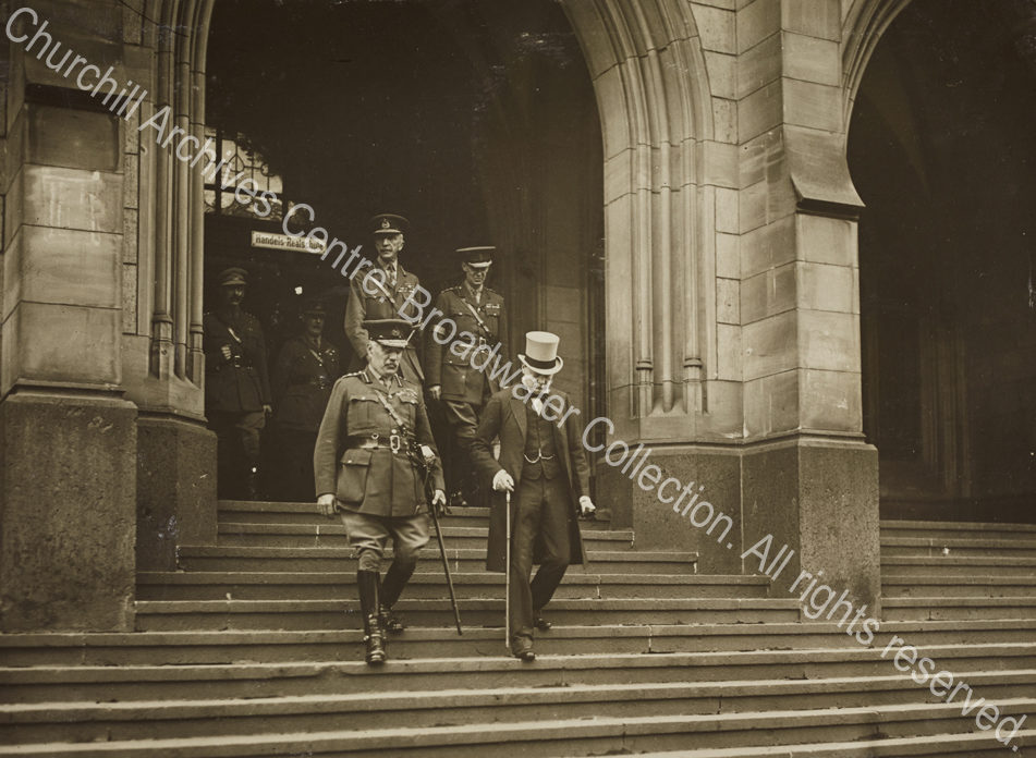 Photograph of WSC [Secretary of State for War] with a group of officers descending the steps of a school [? in Cologne