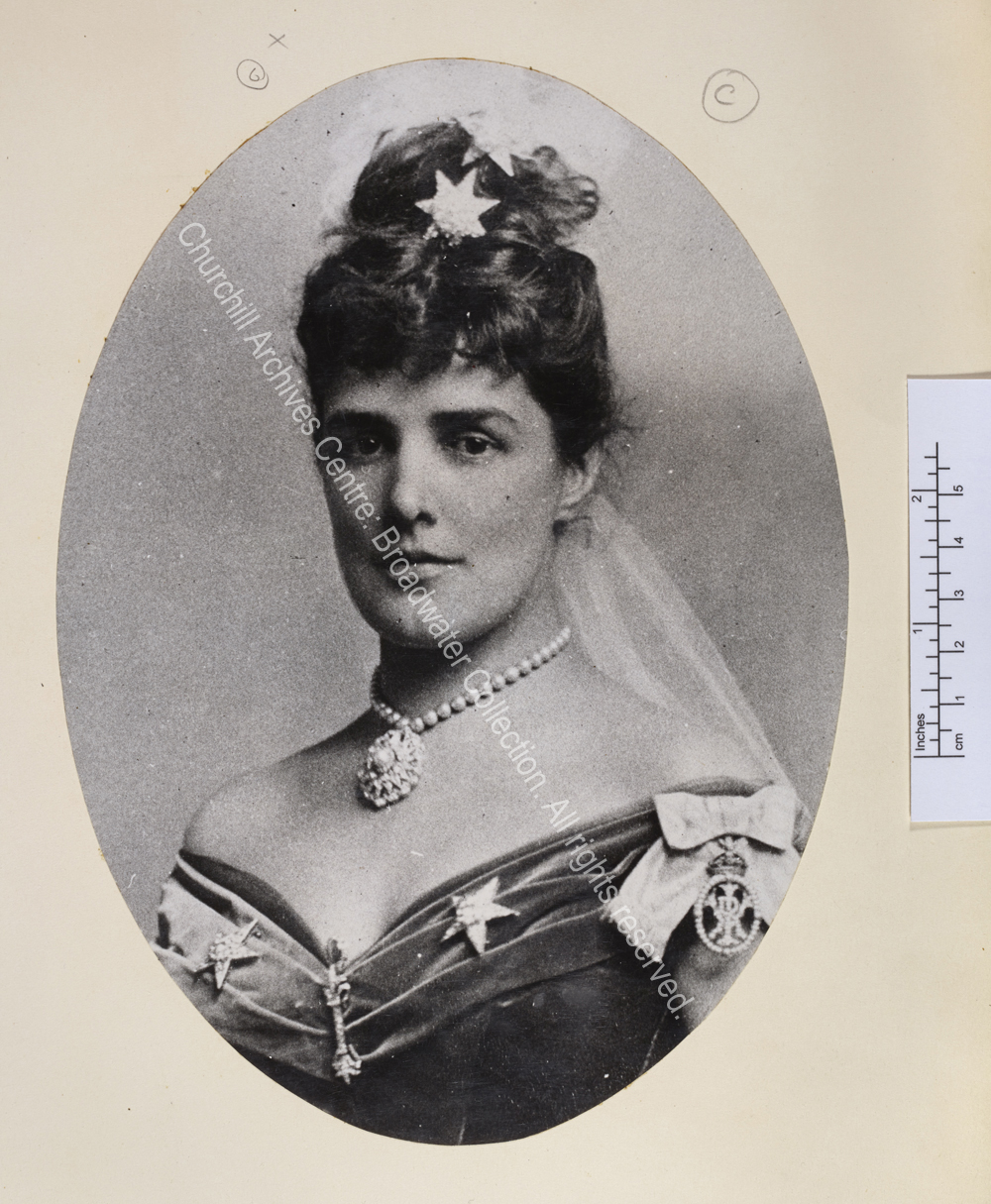 Oval portrait photograph showing Lady Randolph wearing evening dress with jewels in the shape of stars in her hair and on her dress.