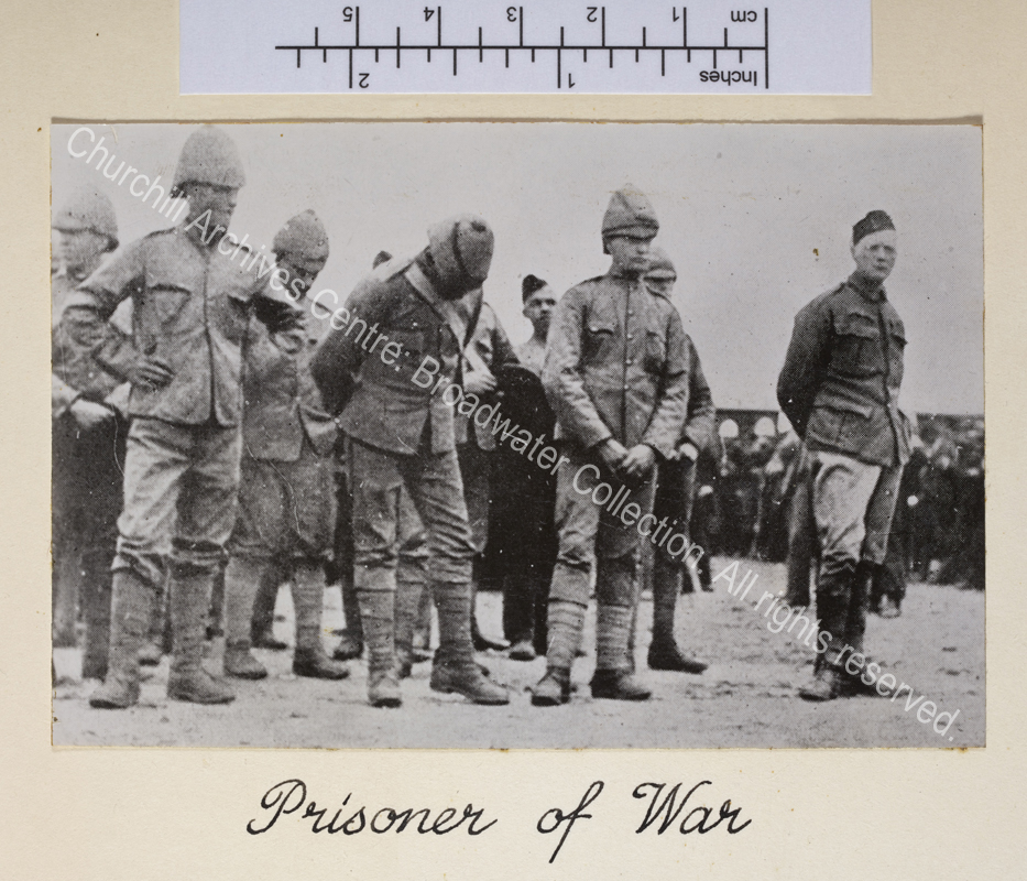 Photograph shows line of prisoners (WSC on the right