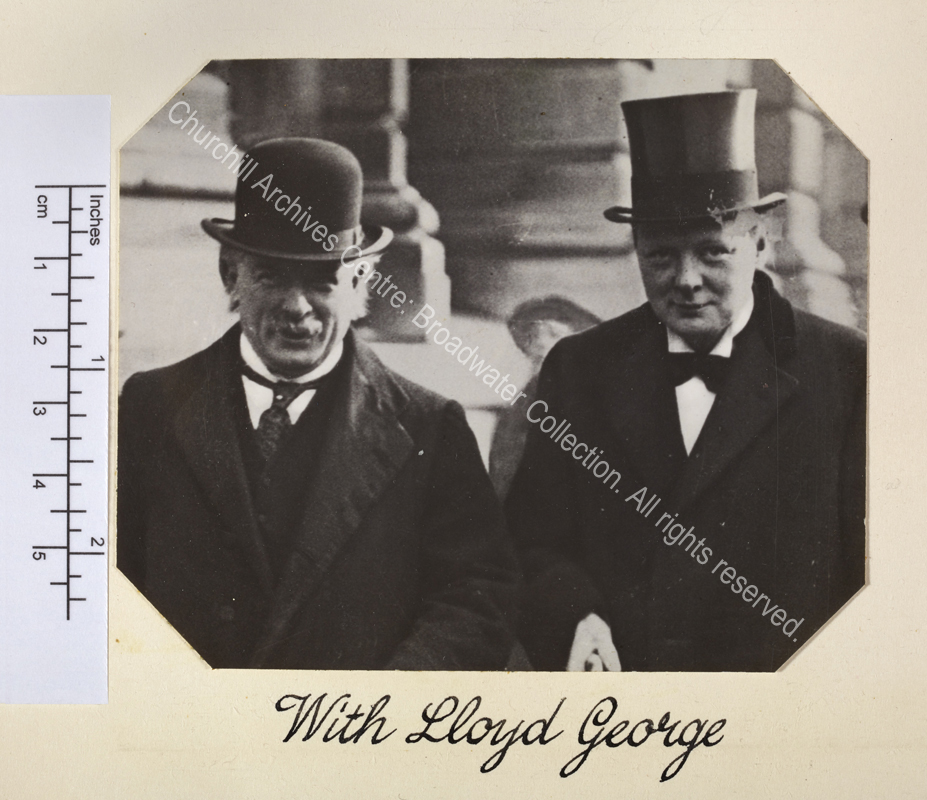 Head and shoulders photograph of WSC and David Lloyd George. Lloyd George is smiling and wearing a bowler hat and WSC is wearing a top hat.