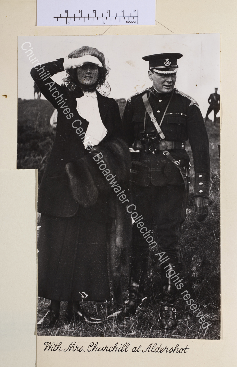 Full length photo of WSC in uniform with CSC shielding her eyes from the sun.
