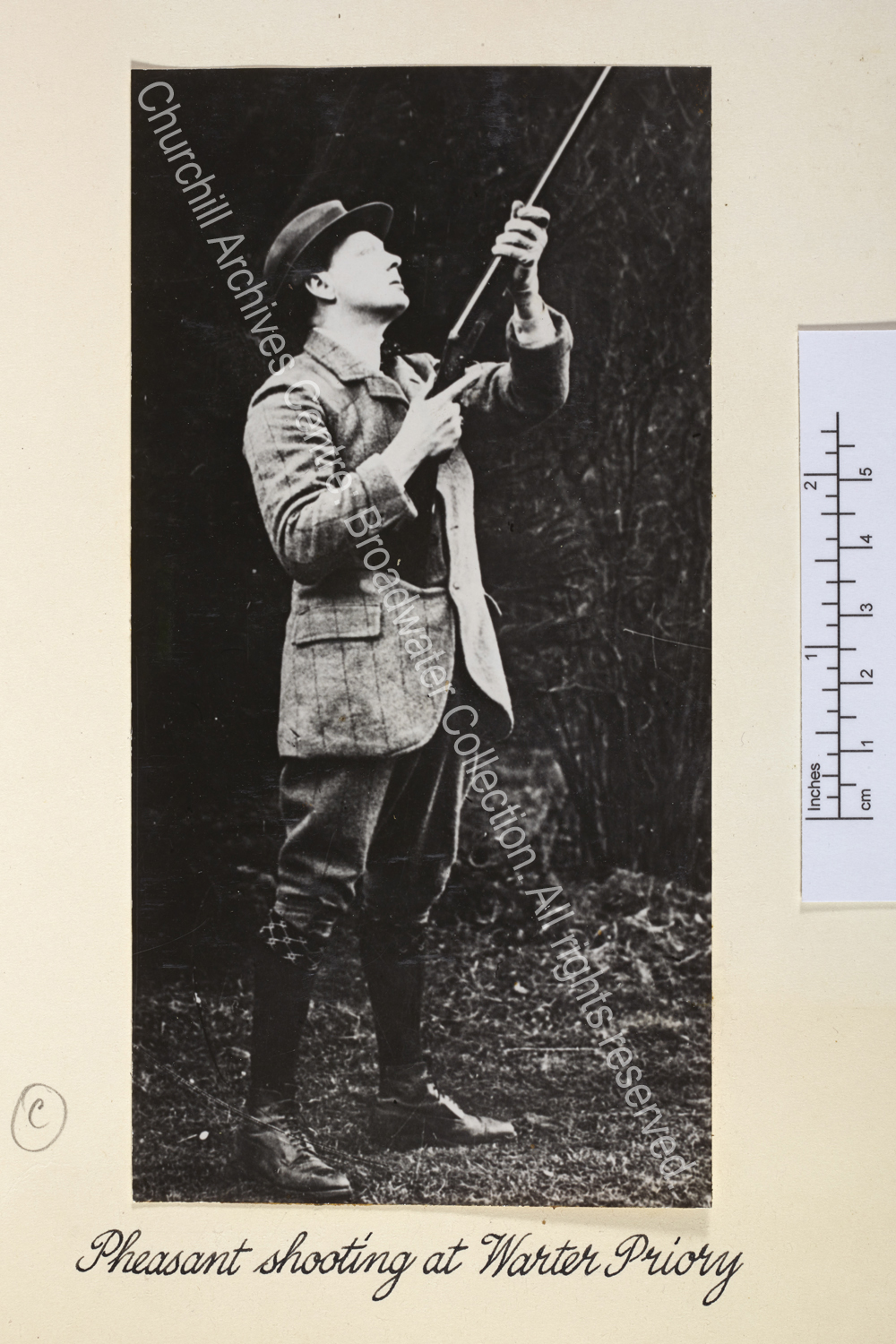Photo shows WSC looking up into the sky holding a gun