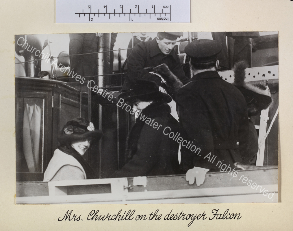 Photo shows CSC wearing a hat seated at the side of the HMS Falcon