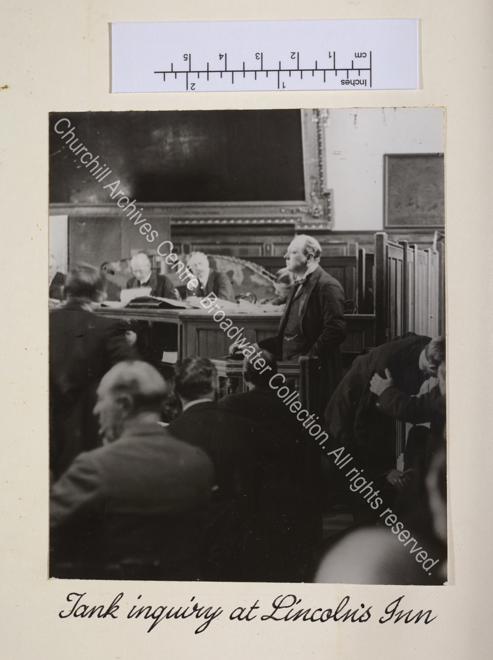 WSC standing in a witness box in the courtroom.