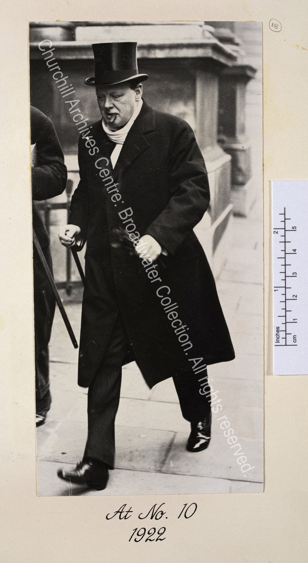 Photo shows WSC walking purposefully wearing a top hat and overcoat