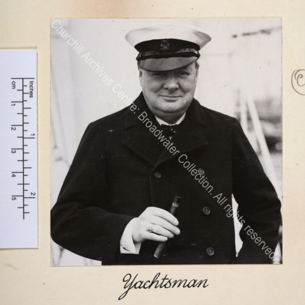 Head and shoulders photo of WSC wearing a yachting cap and holding a large cigar.