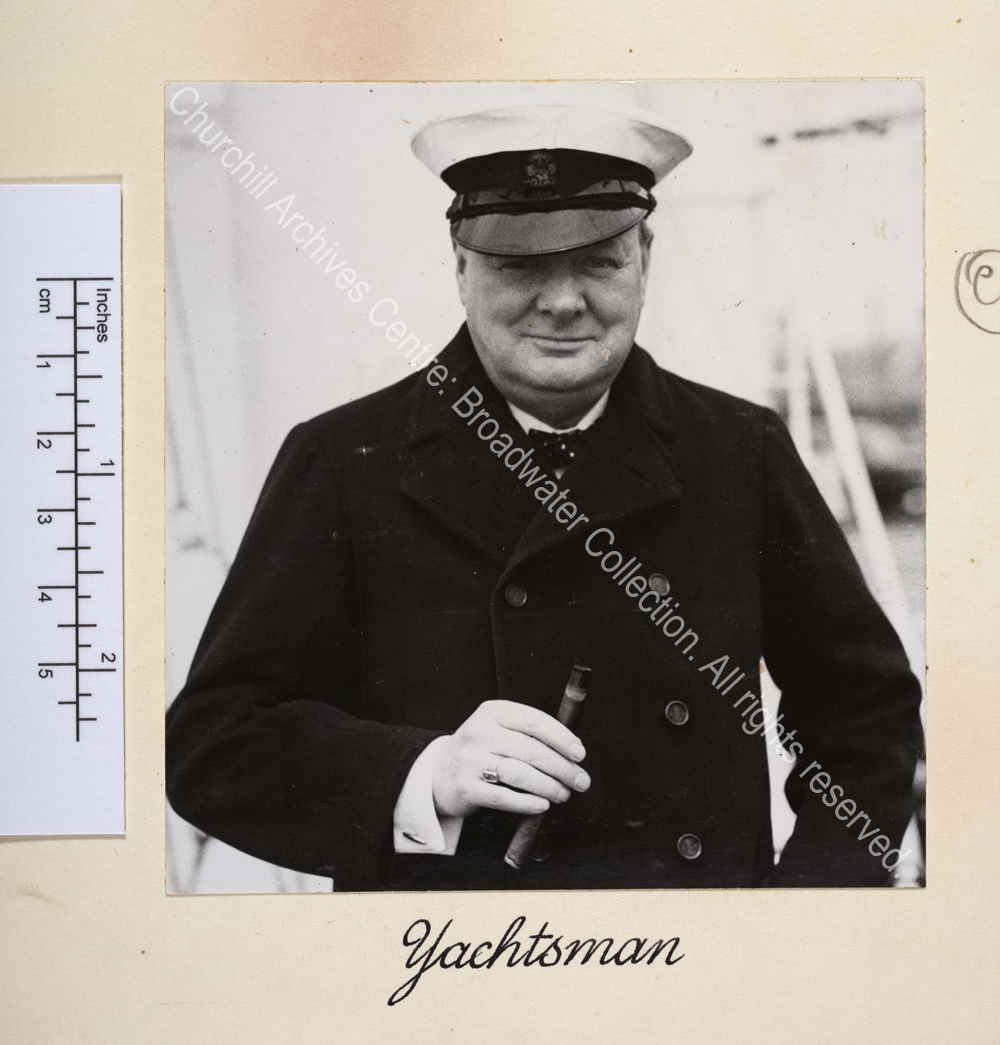 Head and shoulders photo of WSC wearing a yachting cap and holding a large cigar.