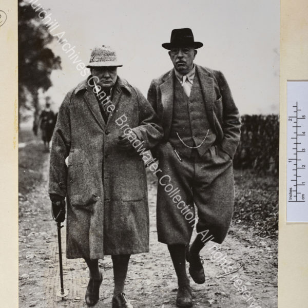 Photo shows WSC wearing tweed overcoat and hat