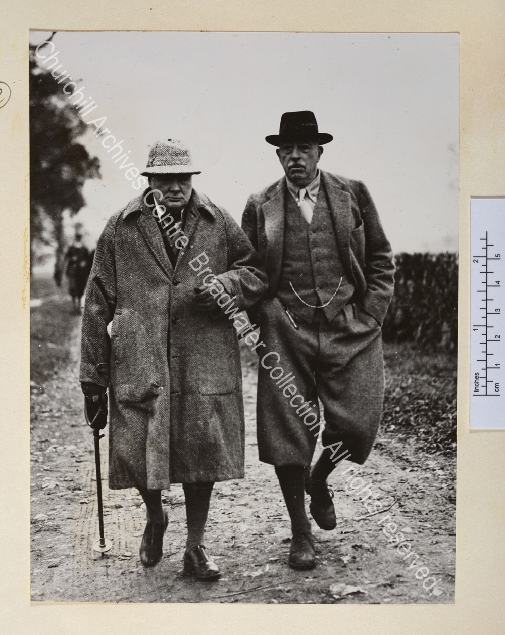 Photo shows WSC wearing tweed overcoat and hat