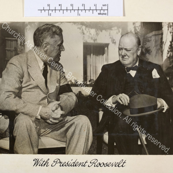Exterior photograph showing WSC and President Roosevelt seated on chairs in conversation.