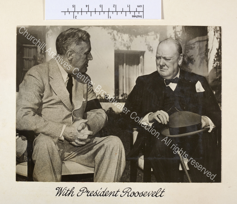 Exterior photograph showing WSC and President Roosevelt seated on chairs in conversation.