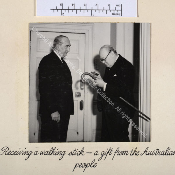 Photo shows WSC being presented with a gift of an Australian blackwood walking stick by Stanley Bruce [later Lord Bruce of Melbourne].