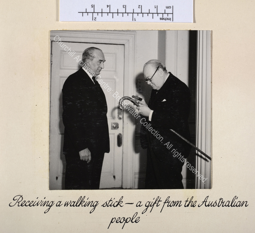 Photo shows WSC being presented with a gift of an Australian blackwood walking stick by Stanley Bruce [later Lord Bruce of Melbourne].