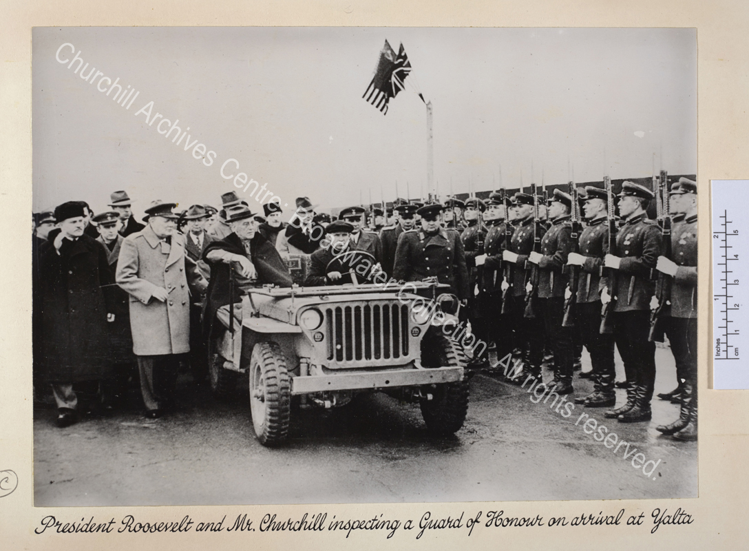 Photo shows WSC and Roosevelt accompanied by a large group of people including Soviet Foreign Minister Vyacheslav Molotov (wearing a dark greatcoat
