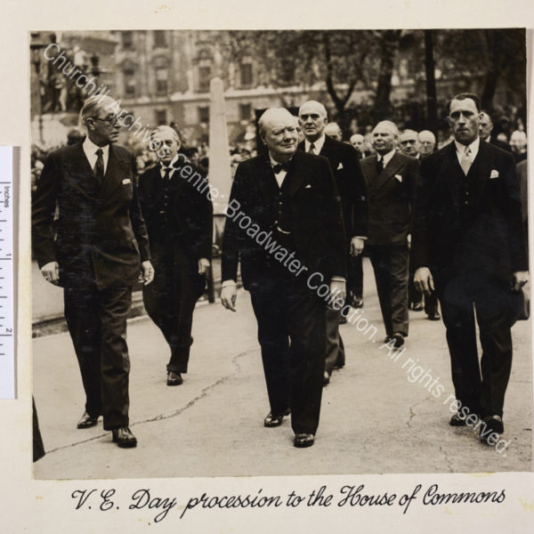 Photo shows WSC walking accompanied by a group of people.