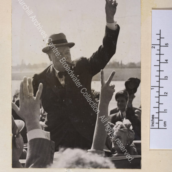 Photo shows WSC standing in an open top car