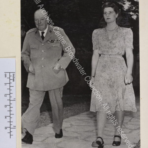 Photo shows WSC and Mary Churchill [later Mary Soames] walking towards the camera. WSC is in uniform and Mary wears a light summer dress.