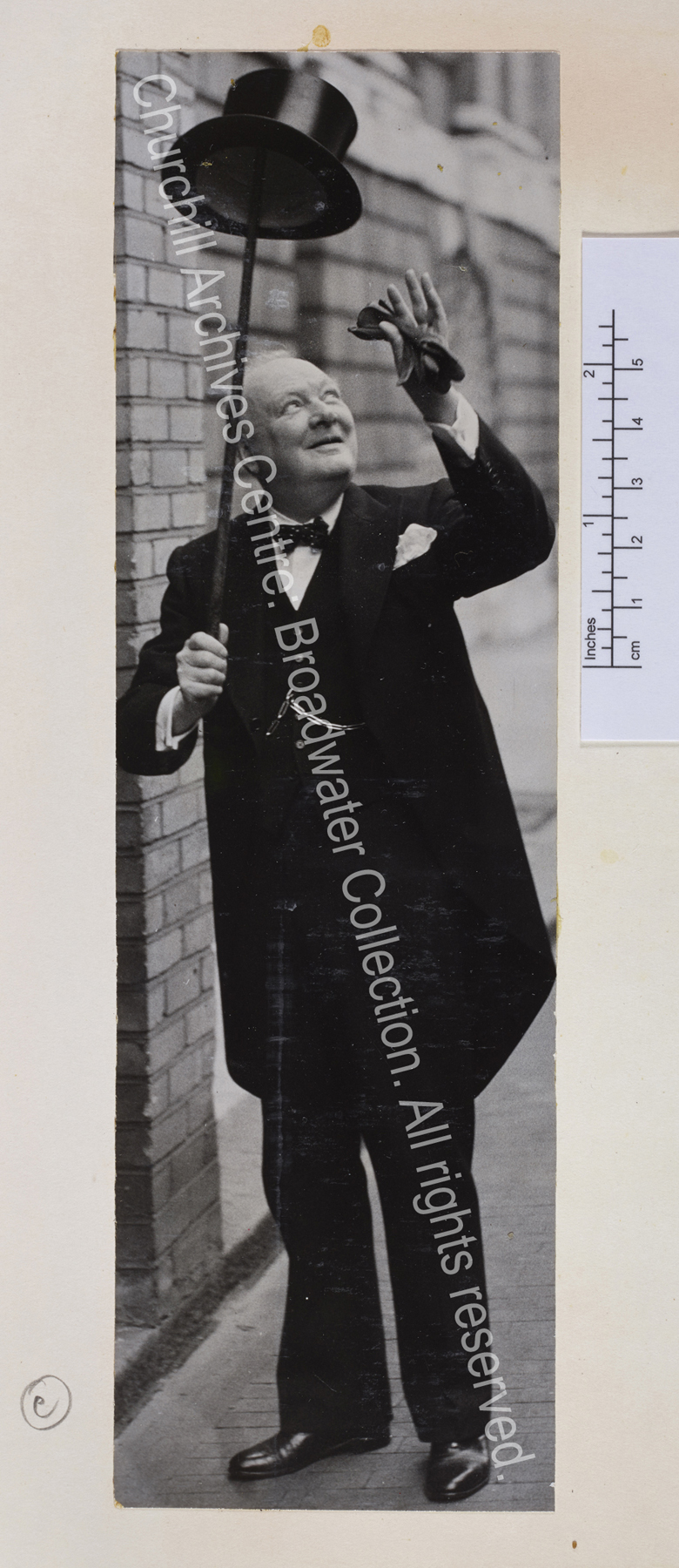 Full length photo of WSC in morning suit and polka dot bow tie
