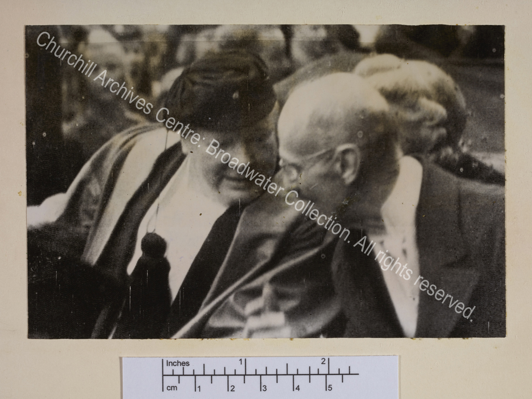 Photo shows WSC wearing a cap and leaning towards King Haakon.
