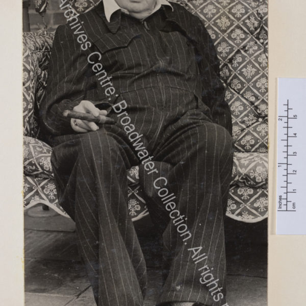 Photo of WSC wearing a pin-striped siren suit and monogrammed slippers