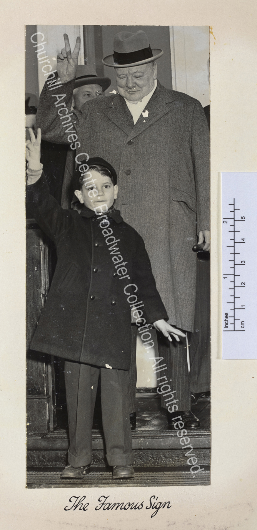 Photo shows WSC [returning from the United States on the Queen Mary] wearing a pale overcoat