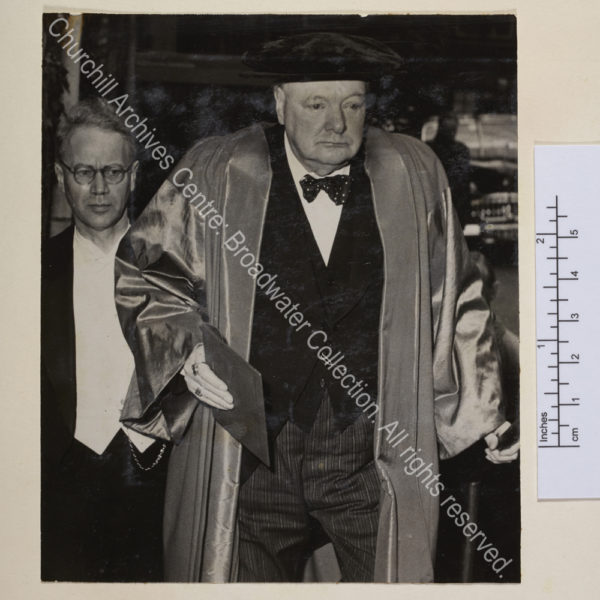 Photo shows WSC in academic dress walking towards the camera [on occasion of receiving an honorary degree from Copenhagen University.