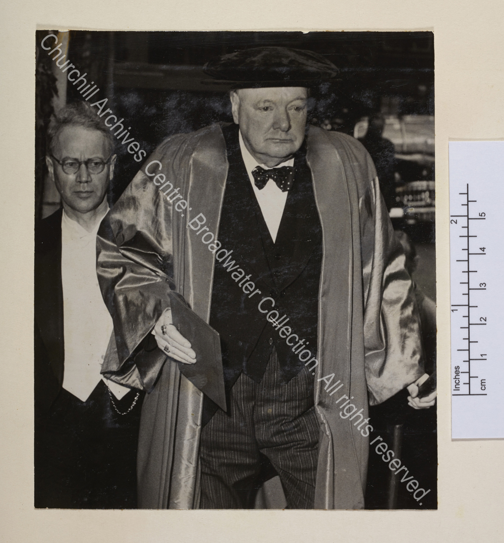 Photo shows WSC in academic dress walking towards the camera [on occasion of receiving an honorary degree from Copenhagen University.