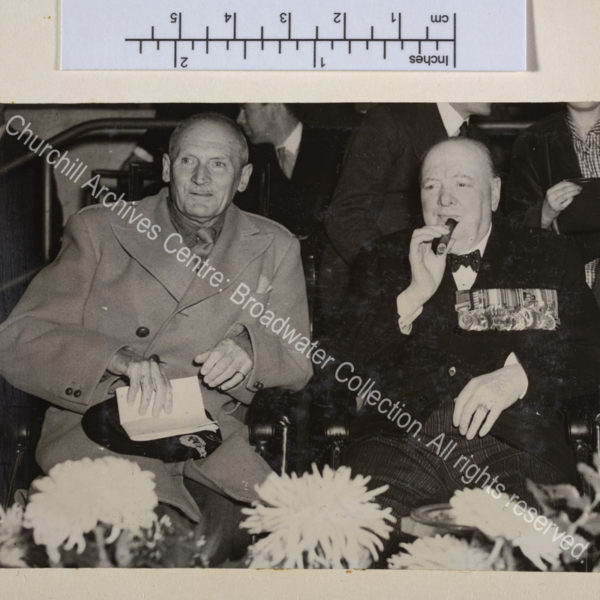 Photo of WSC and [1st Lord] Montgomery of Alamein seated side by side. WSC is wearing medals.