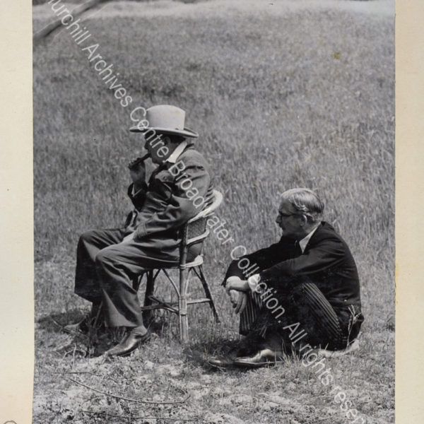 Exterior photo showing WSC wearing a siren suit and a broad brimmed hat
