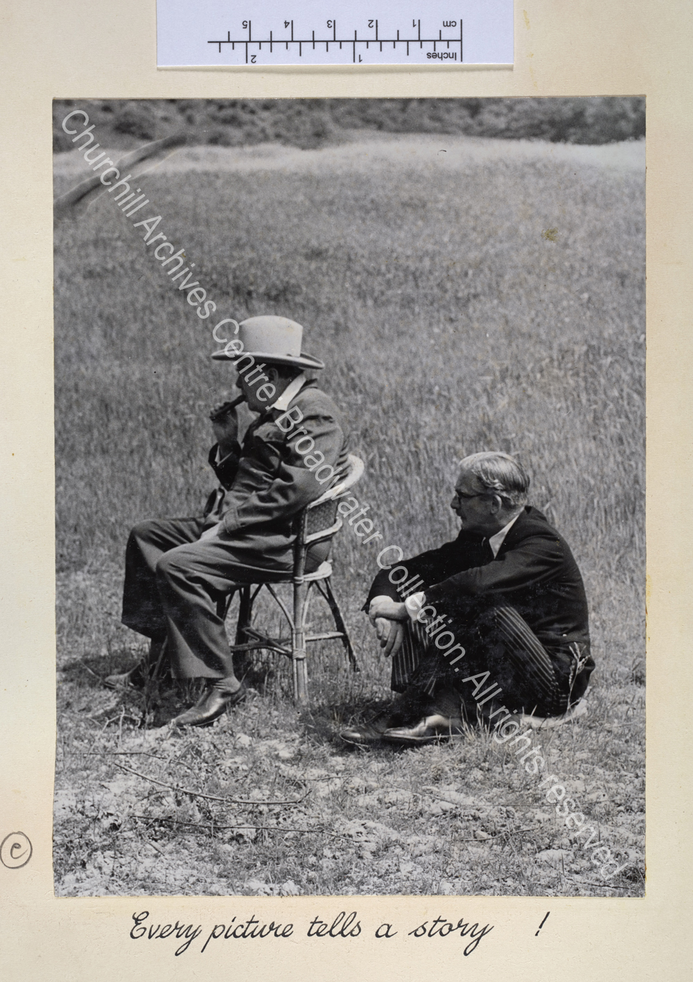 Exterior photo showing WSC wearing a siren suit and a broad brimmed hat