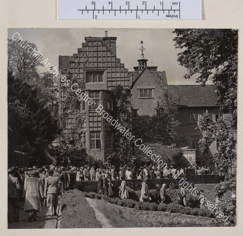 Exterior view of the south front at Chartwell with crowds of people queuing and walking in the grounds.