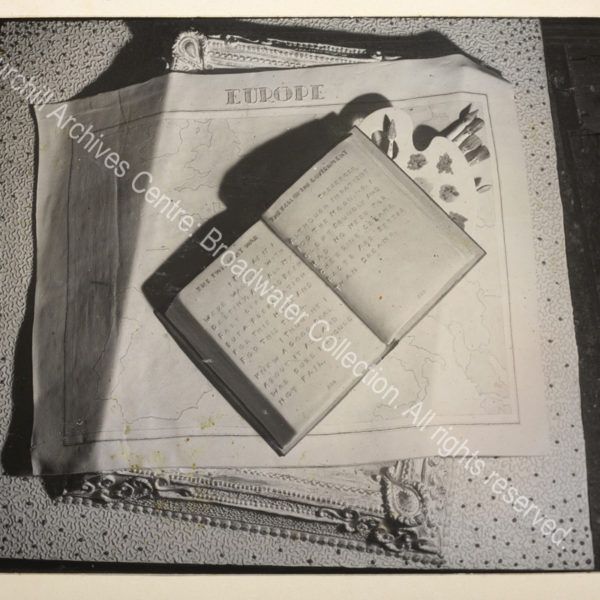 Birthday cake illustrating some of WSC's activities: an open copy of WSC's "The Second World War" is arranged on top of an easel and paintbrushes