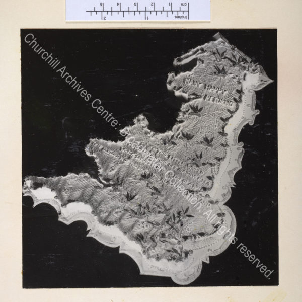 Cake in the shape of a map of England and Wales iced with a birthday greeting and a quote by WSC about England.
