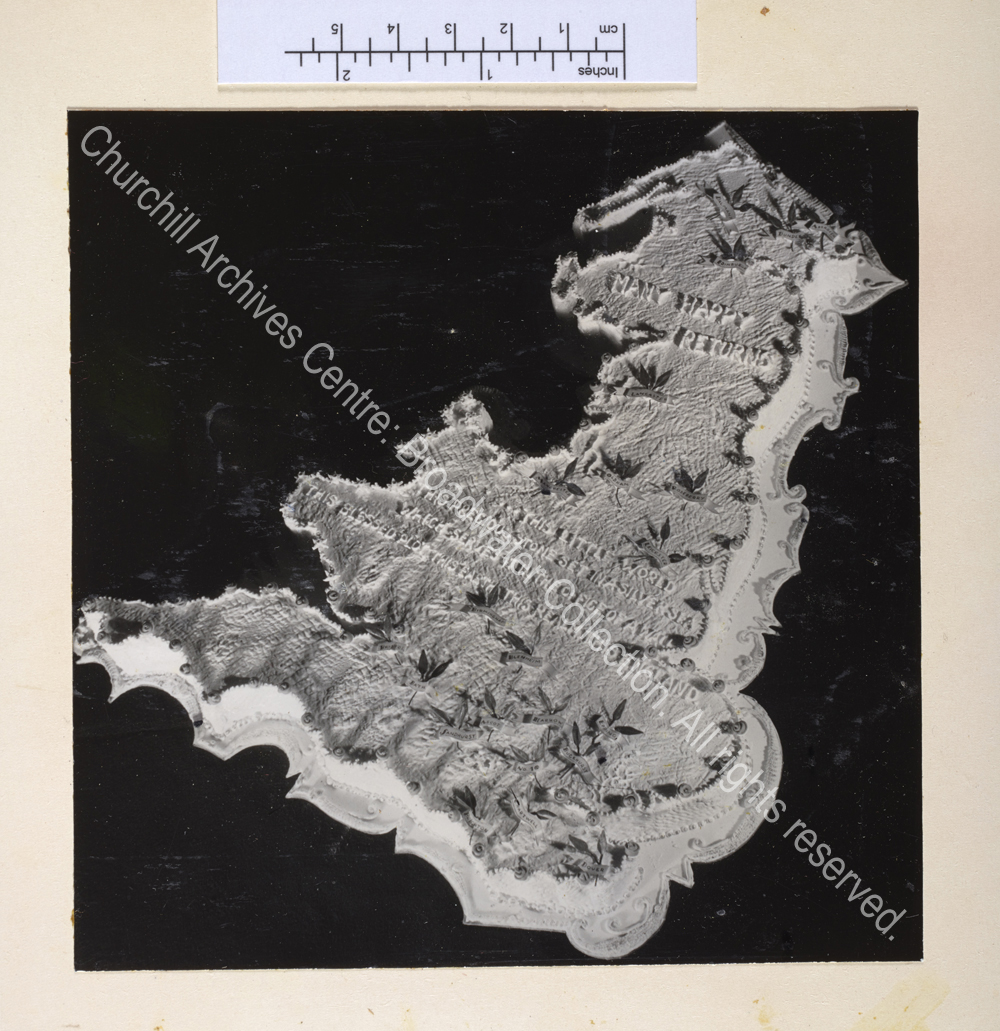 Cake in the shape of a map of England and Wales iced with a birthday greeting and a quote by WSC about England.