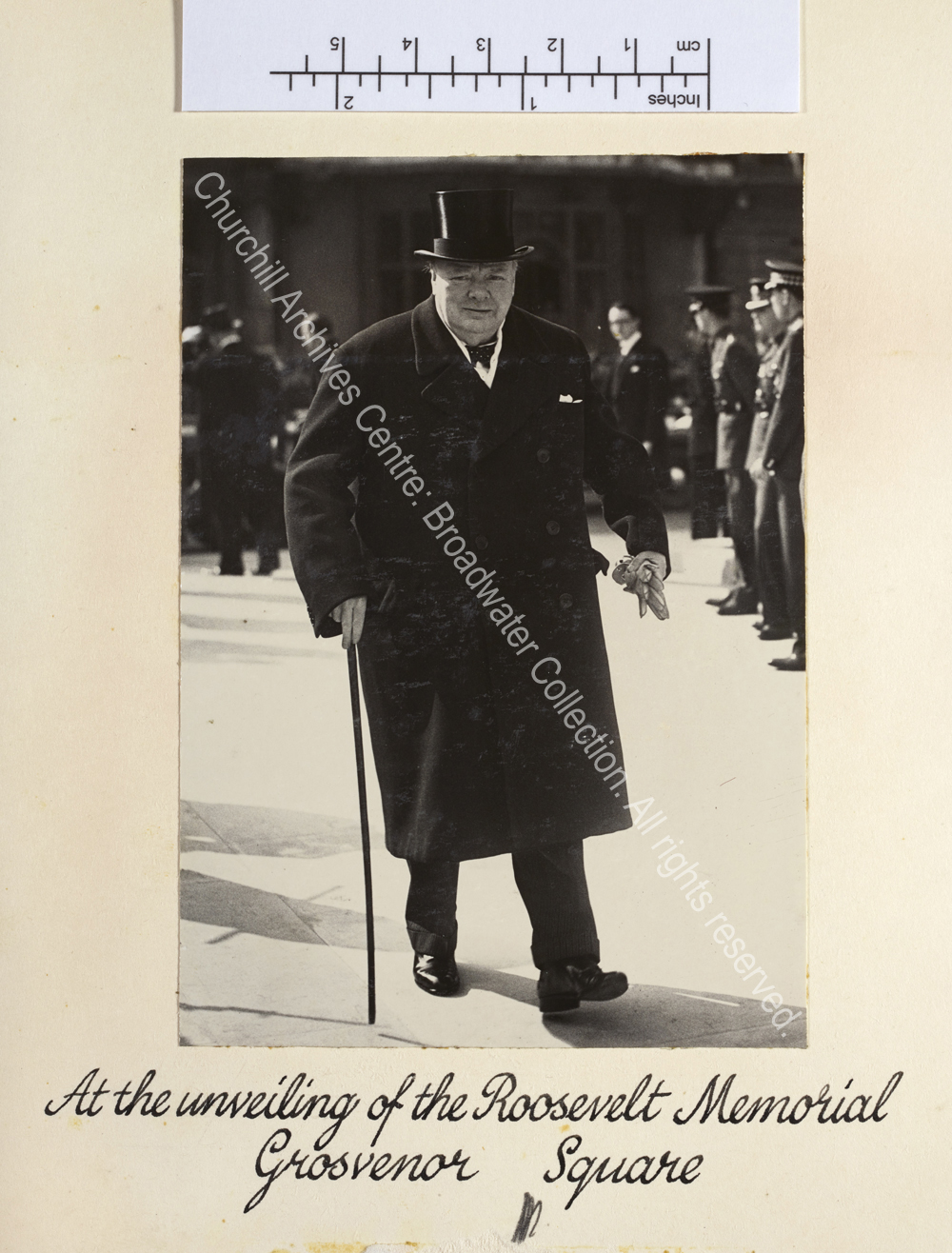 Photo shows WSC walking towards the camera. He is wearing an overcoat and top hat