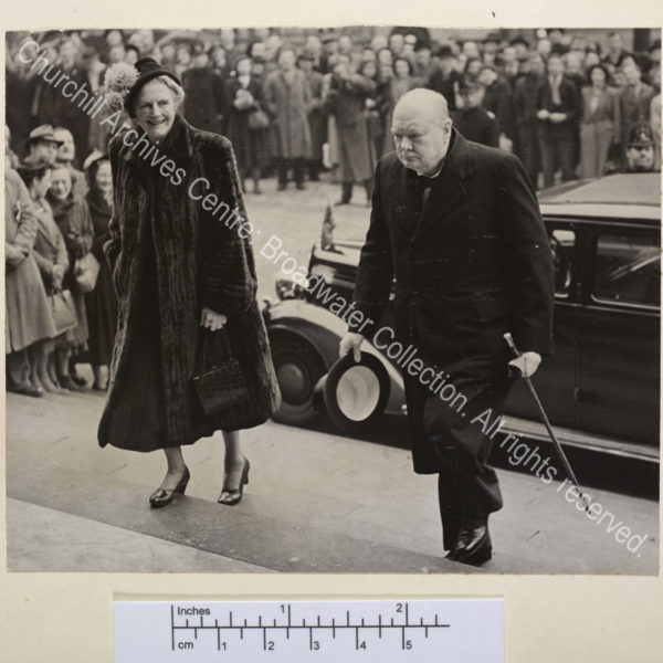 Photograph showing WSC and CSC walking up wide steps. CSC is wearing a fur coat.