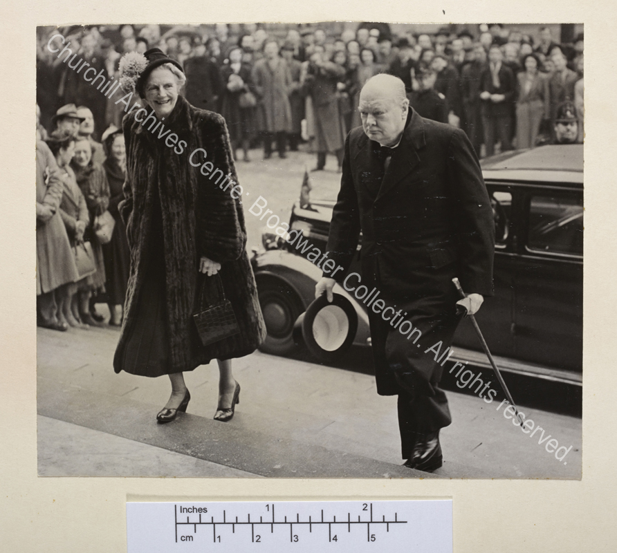 Photograph showing WSC and CSC walking up wide steps. CSC is wearing a fur coat.