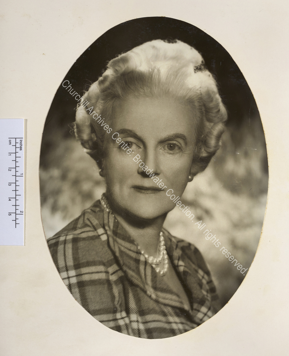Oval portrait photograph of CSC wearing pearl earrings and necklace and a blouse with a tartan pattern. Possibly by Vivienne [Mrs Florence Entwistle also known as Florence Vivienne Mellish].