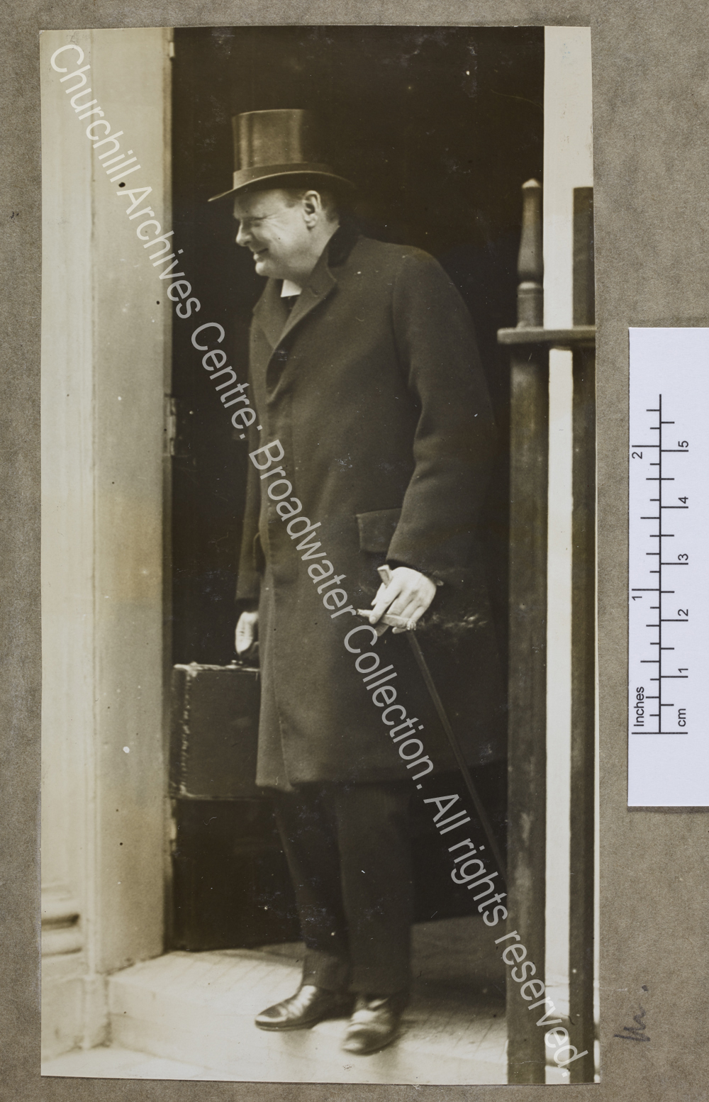 Full length photograph of WSC standing in the doorway of 11 Downing Street
