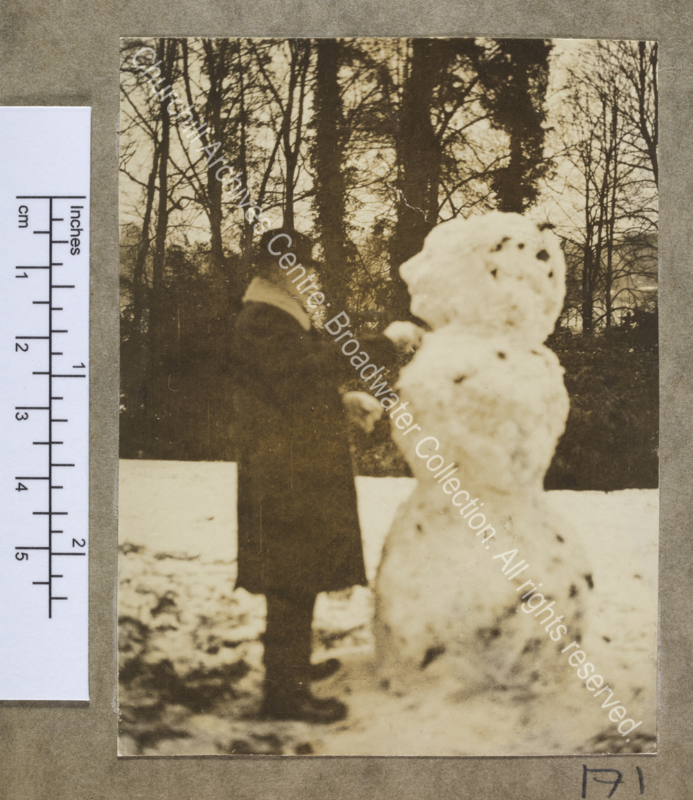 Full length photograph of WSC building a snowman at Chartwell [Kent].  WSC
