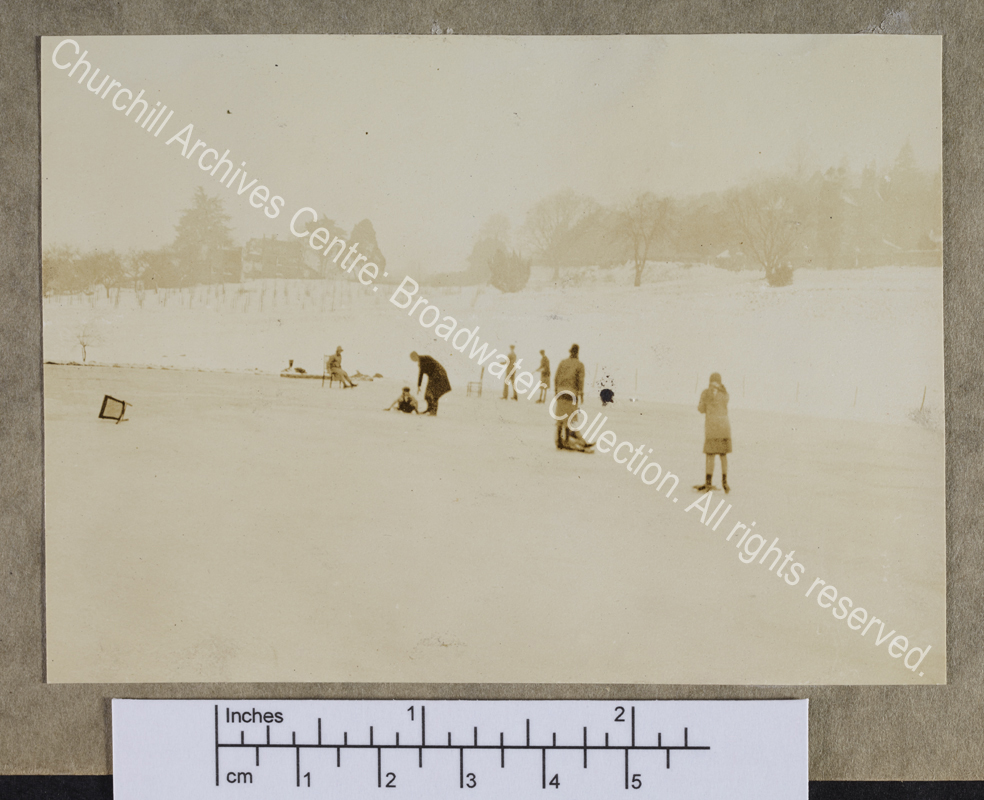 Photograph of CSC and other members of the Churchill family (too small to identify) on the frozen lake at Chartwell [Kent]