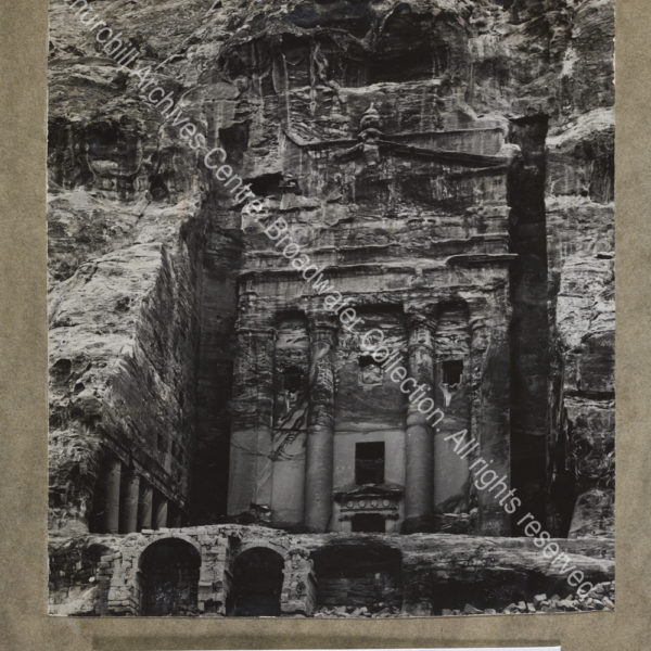 Photograph of a building carved into rock at [Jordan]